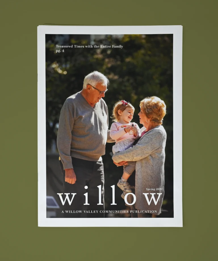 Cover of the Spring 2020 edition of Willow, a Willow Valley Communities Publication. The cover features an older couple in sunlight with trees in the background, holding a toddler, smiling together. There is a callout for page 4, titled "Treasured Times with the Entire Family."