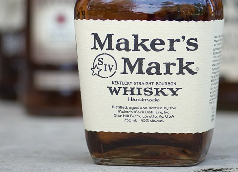 Close-up of a Makers Mark Kentucky Straight Bourbon Whisky bottle label, showing the brand name and product details in bold black text on a cream background.