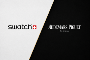A split background with the Swatch logo and Swiss flag on the left in black text on white, and the Audemars Piguet logo with Le Brassus in white text on black on the right.